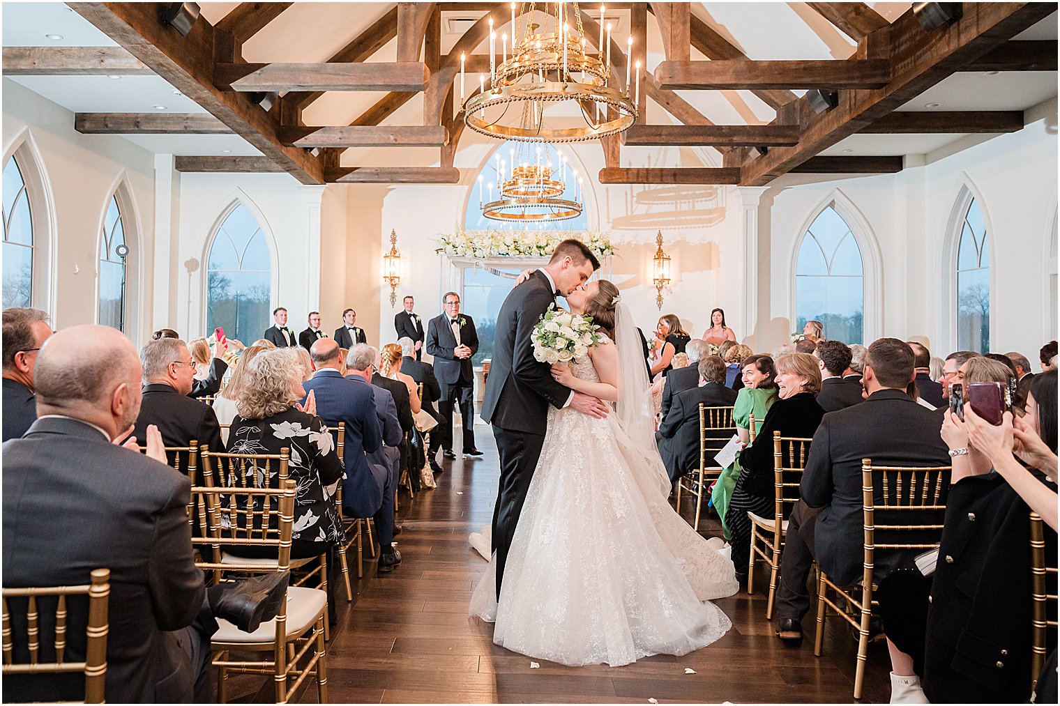 bride and groom kiss in aisle after chapel at Park Savoy Estate