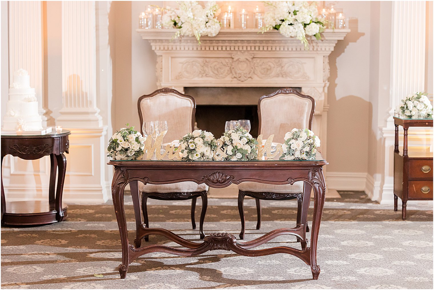sweetheart table by fireplace at Park Savoy Estate with white roses