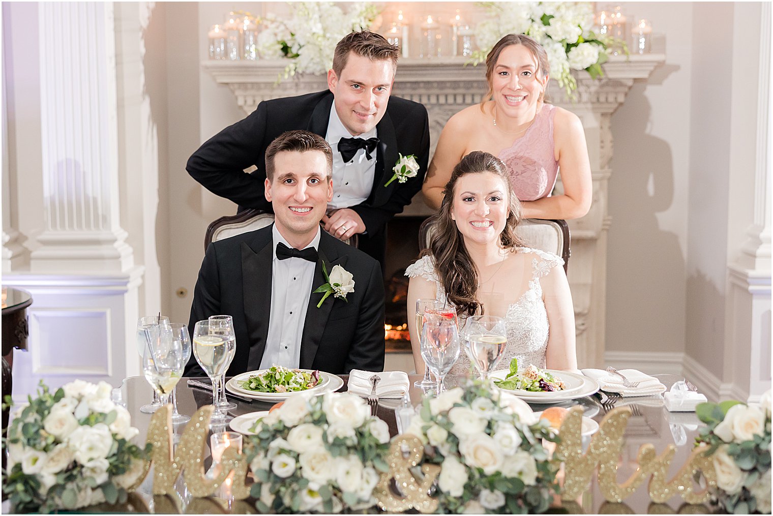 bride and groom pose with maid of honor and best man at sweetheart table at Park Savoy Estate