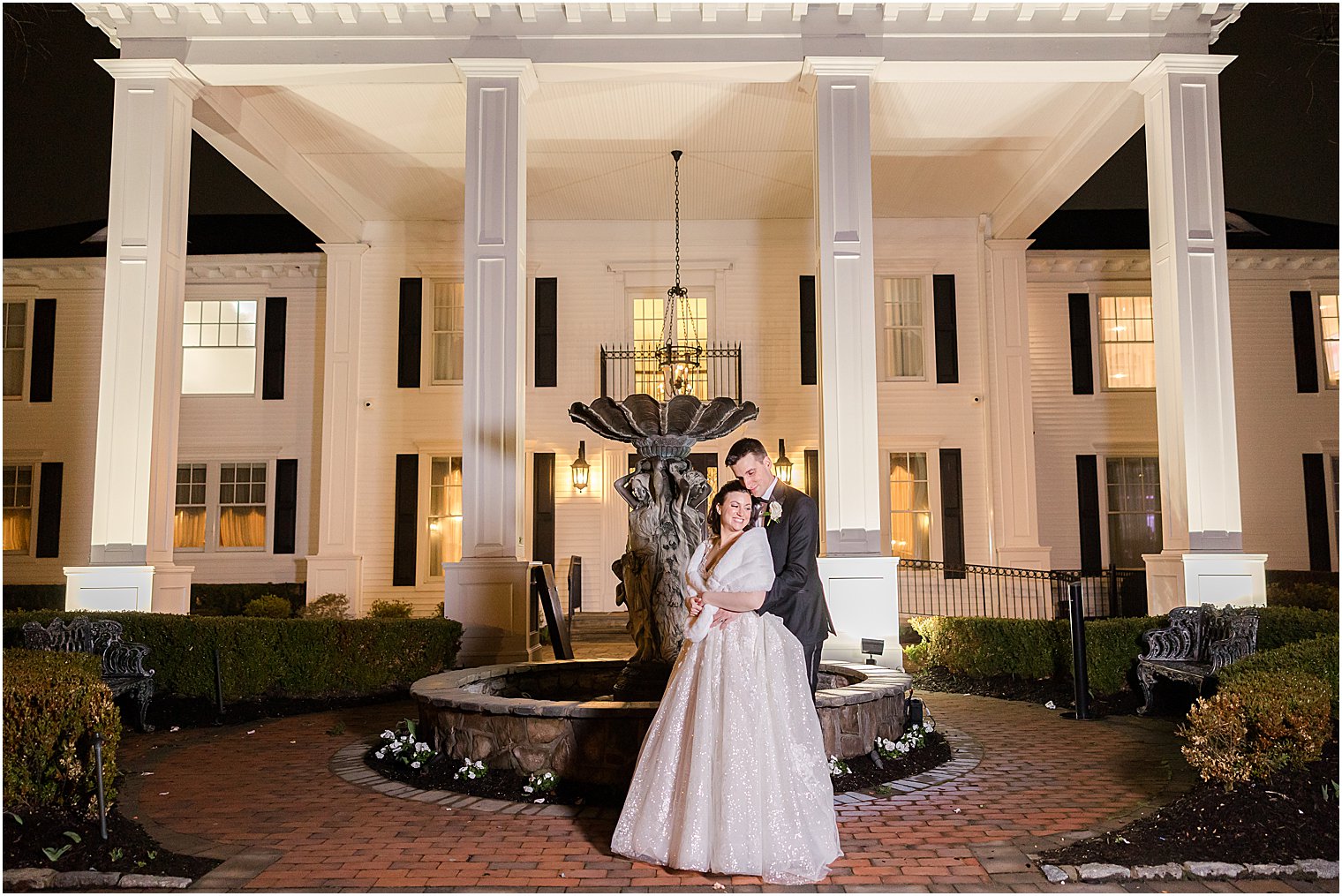 groom hugs bride at night outside Park Savoy Estate 