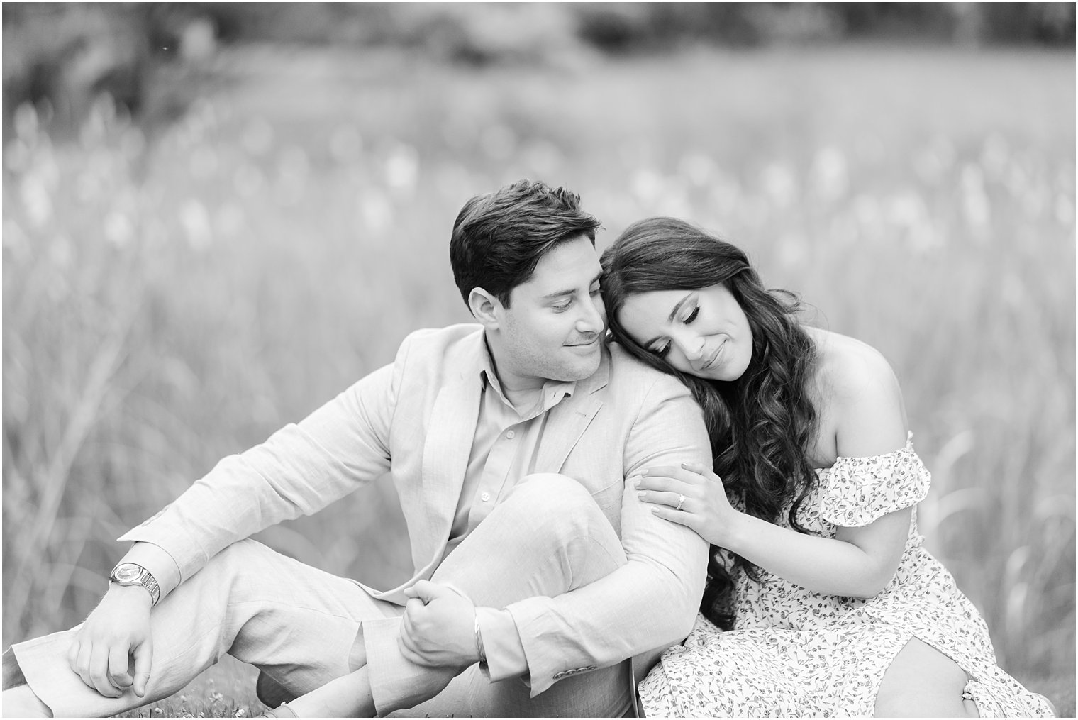 woman sits next to fiancee leaning head on his shoulder during Sayen Gardens engagement session