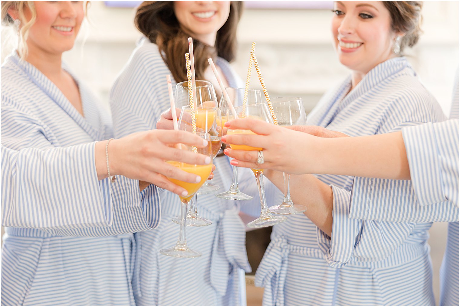 bride and bridesmaids toast champagne glasses 