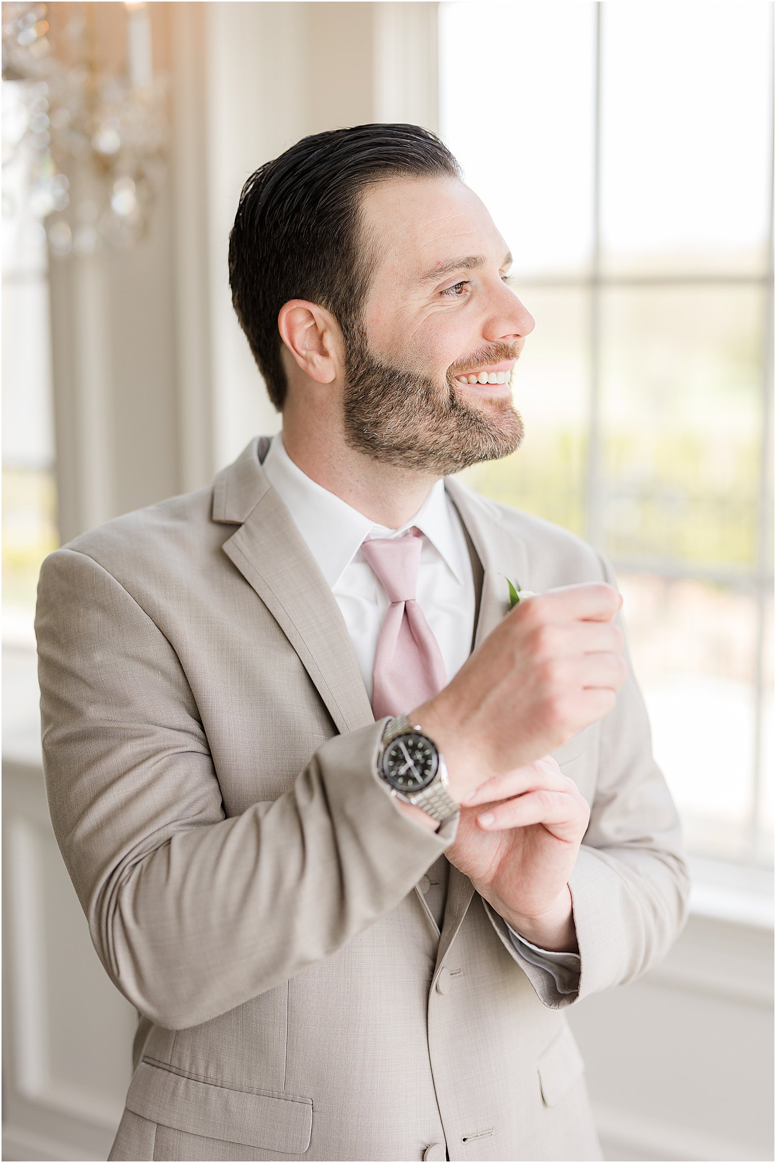 groom adjusts cufflinks at Park Savoy Estate