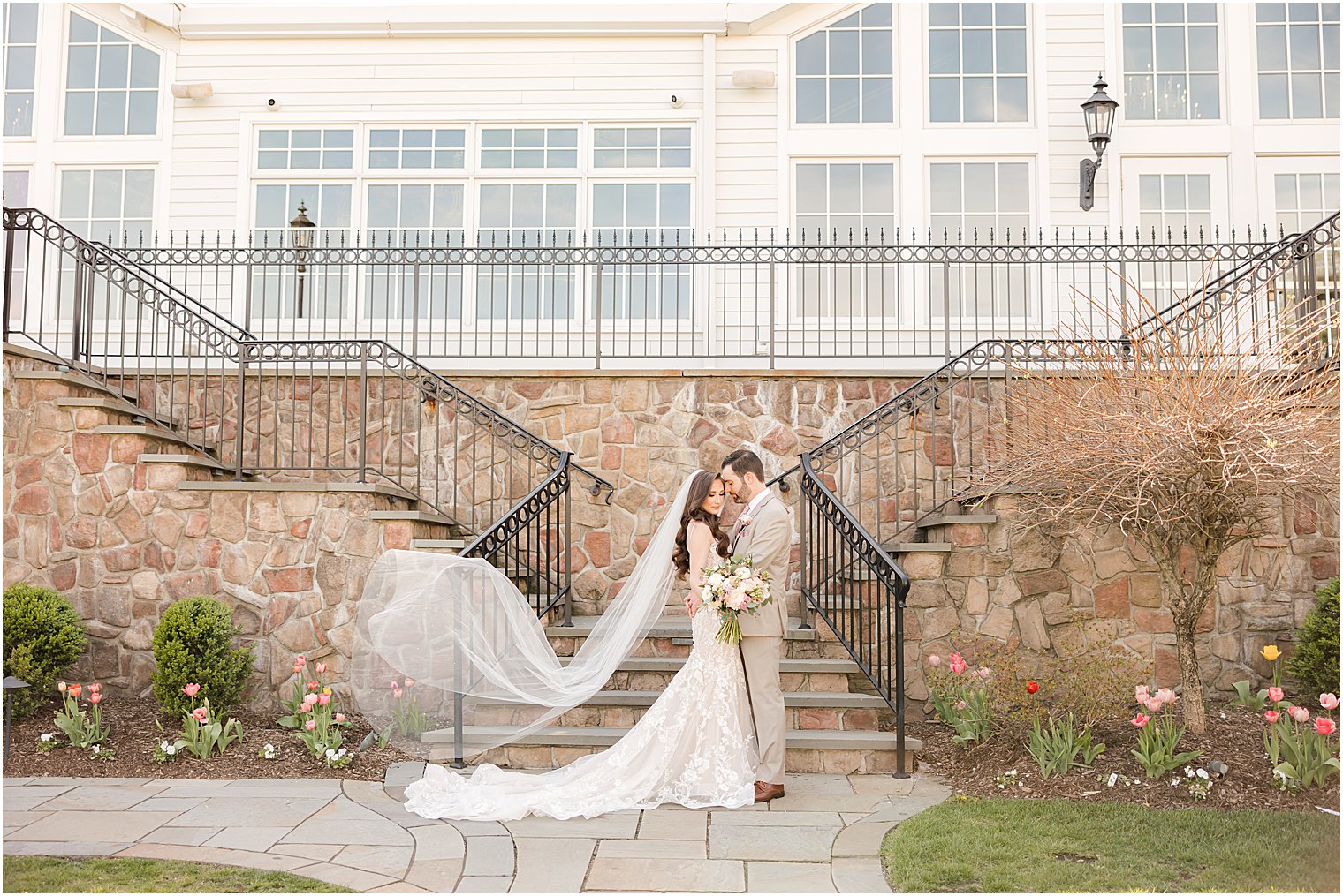 newlyweds hug by stone staircase at Park Savoy Estate