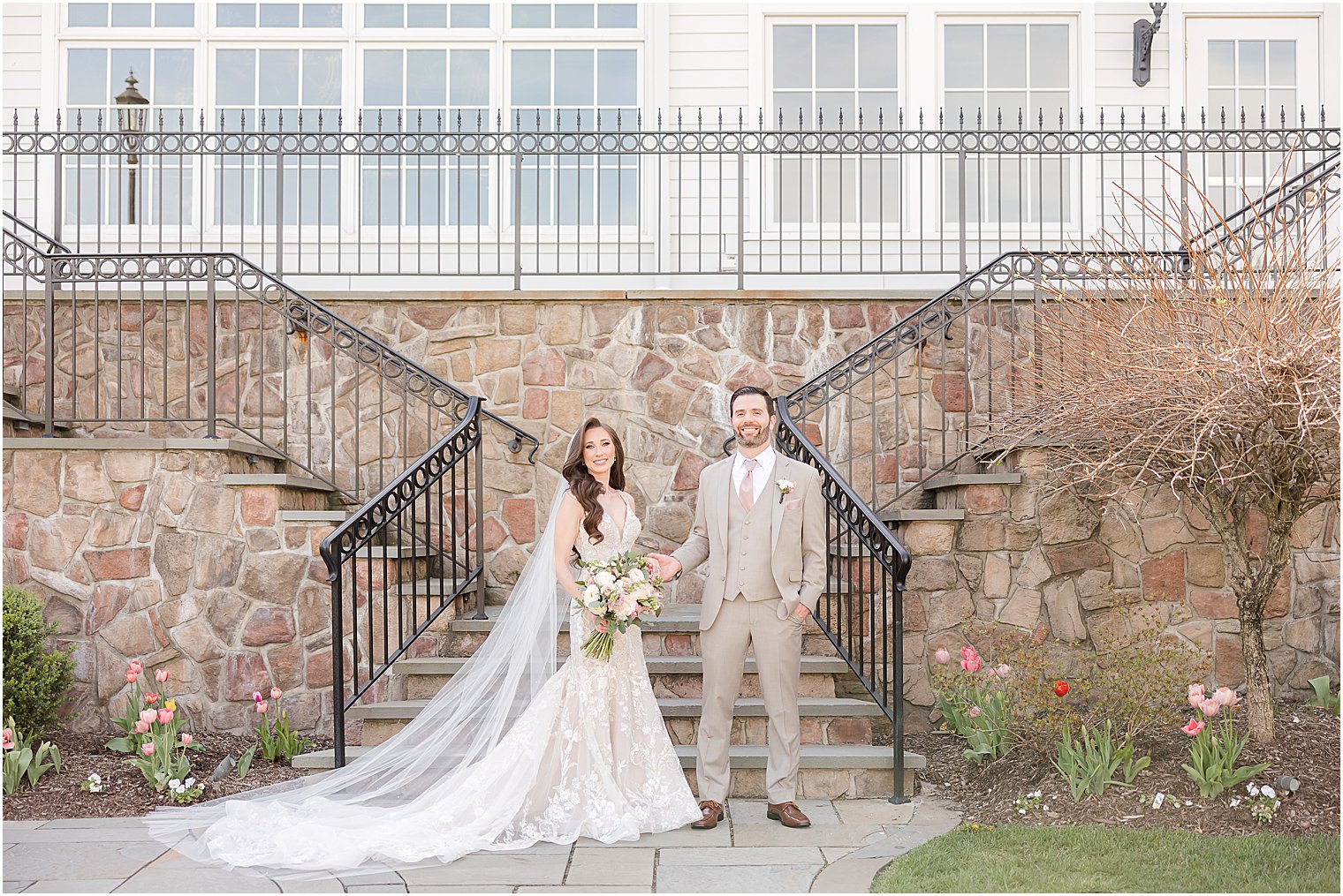 bride and groom hold hands by stone staircase at Park Savoy Estate