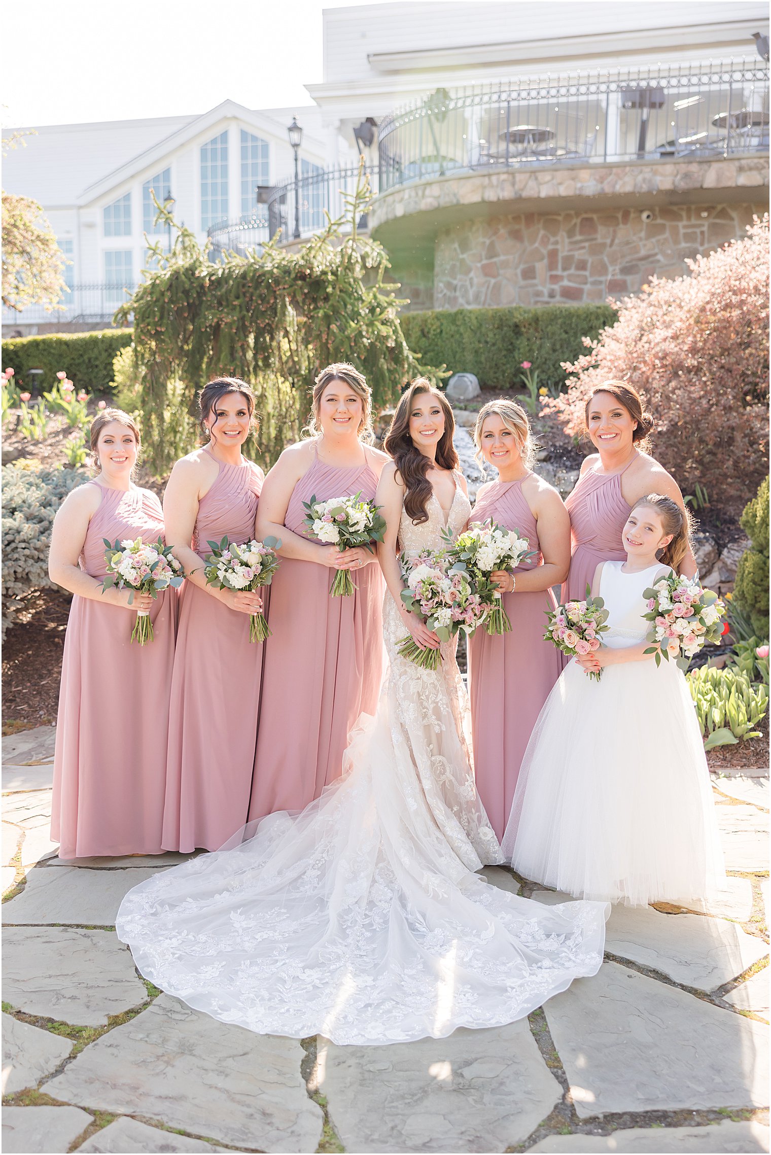 bride stands with bridesmaids in pink gowns at Park Savoy Estate