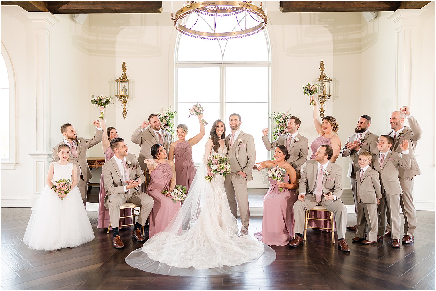 newlyweds hug in chapel at Park Savoy Estate with wedding party around them 