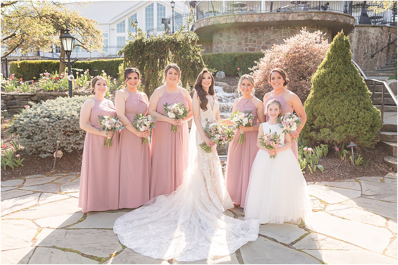 bride stands with bridesmaids in pink gowns for spring wedding at Park Savoy Estate