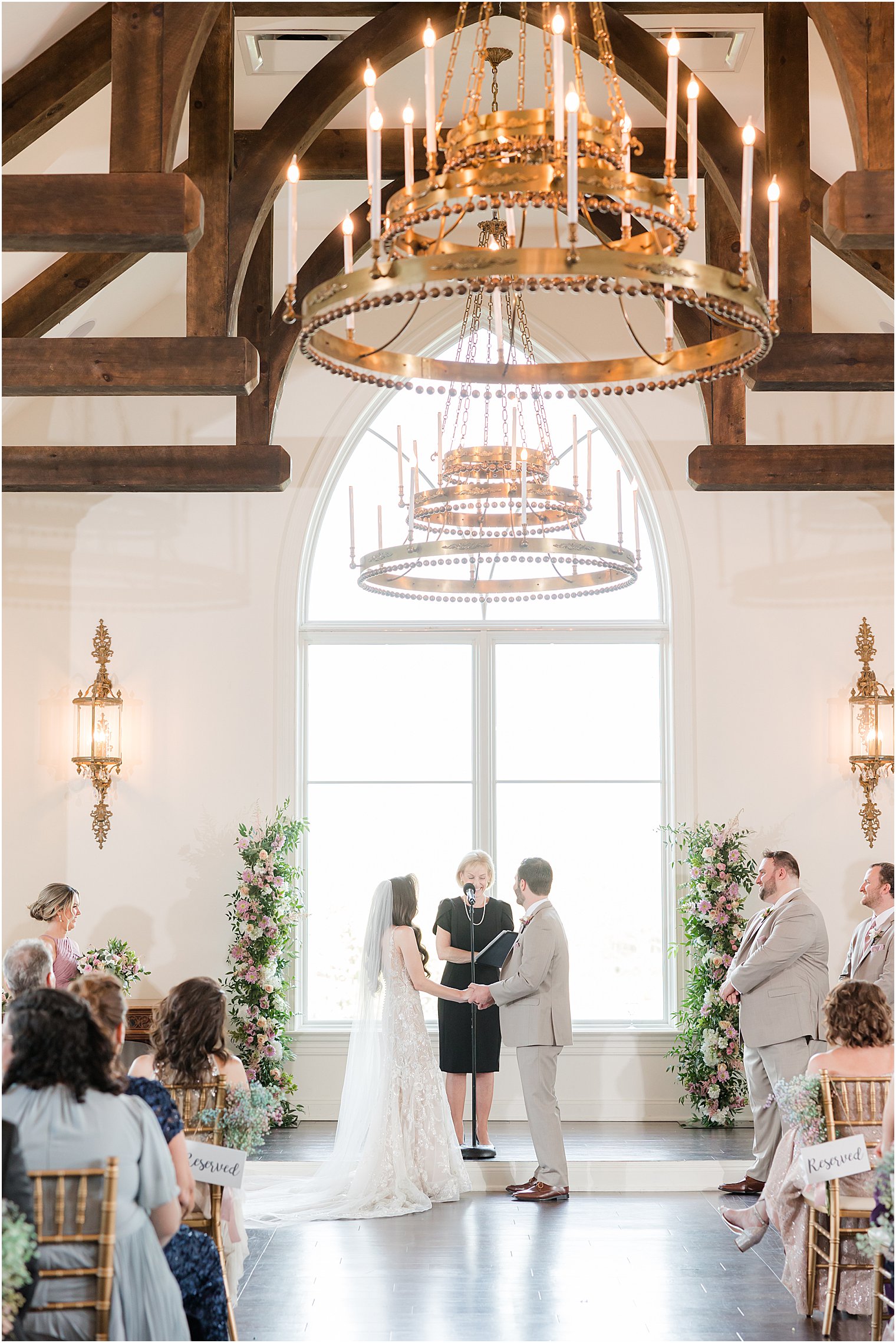 newlyweds hold hands during wedding ceremony in Park Savoy Estate chapel