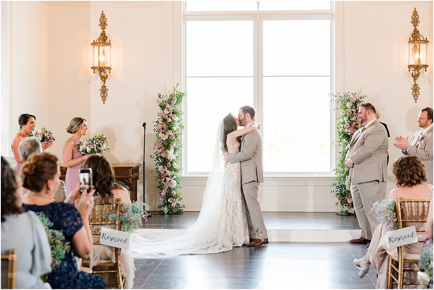 bride and groom kiss during wedding ceremony in Park Savoy Estate chapel