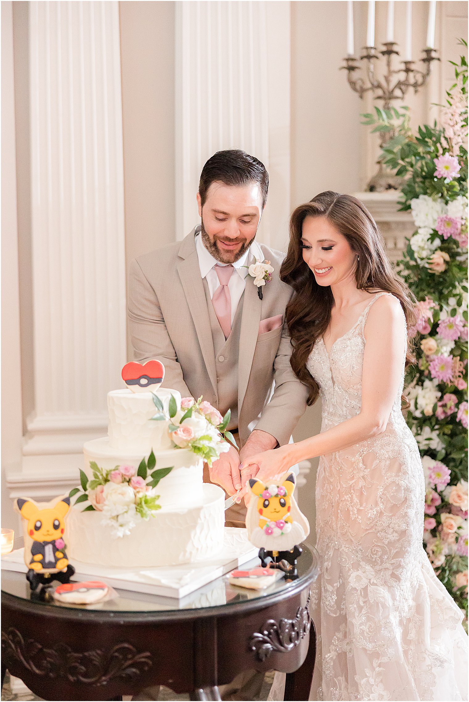 newlyweds cut wedding cake with pokemon cakes 