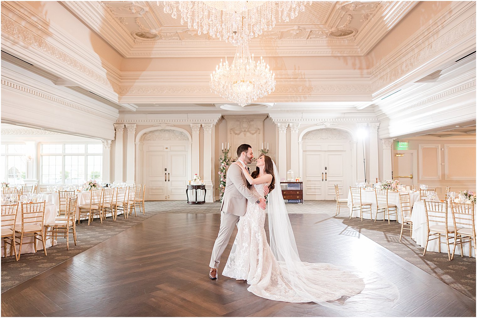 bride and groom hug in ballroom during New Jersey wedding reception 