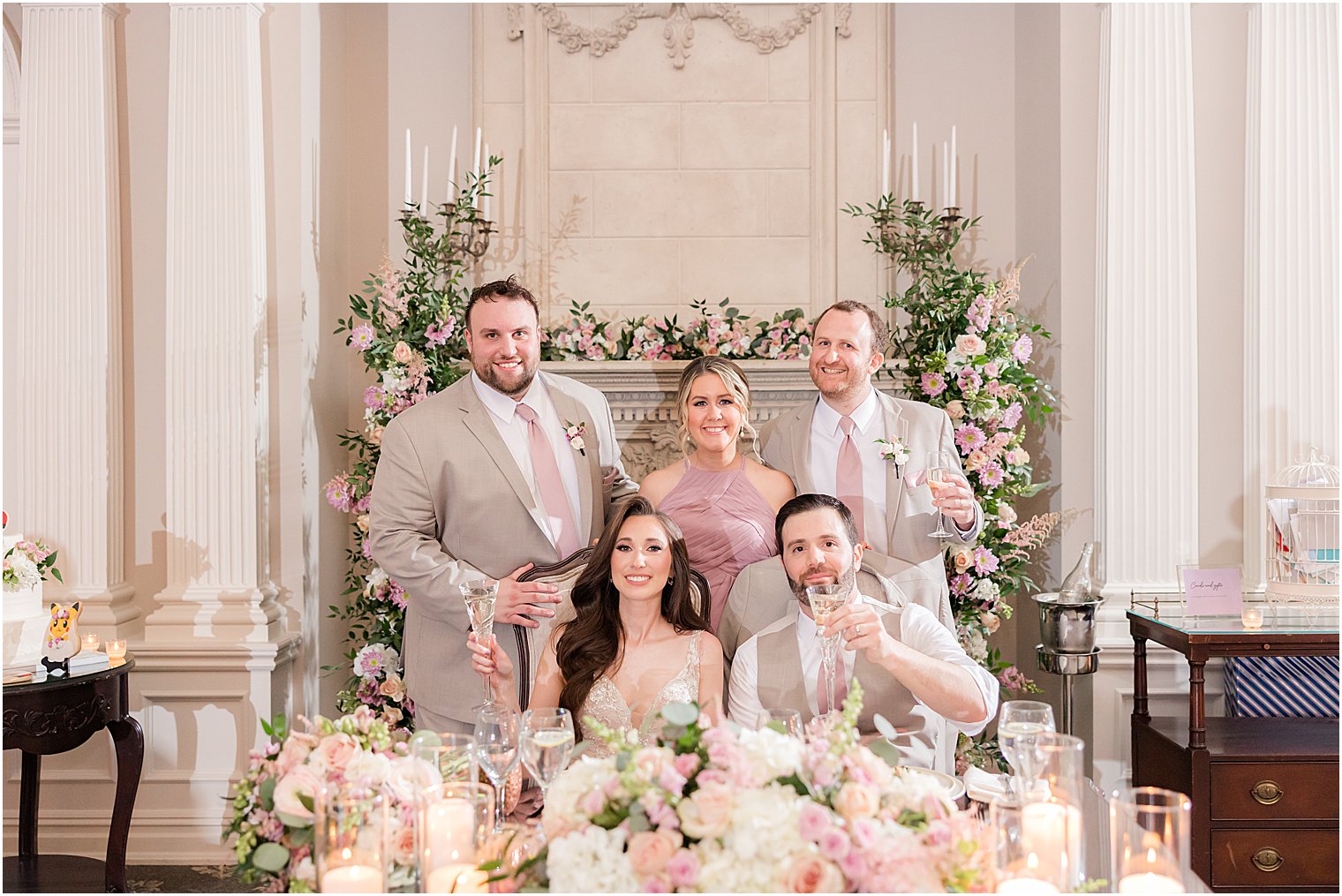 newlyweds sit with best men and maid of honor