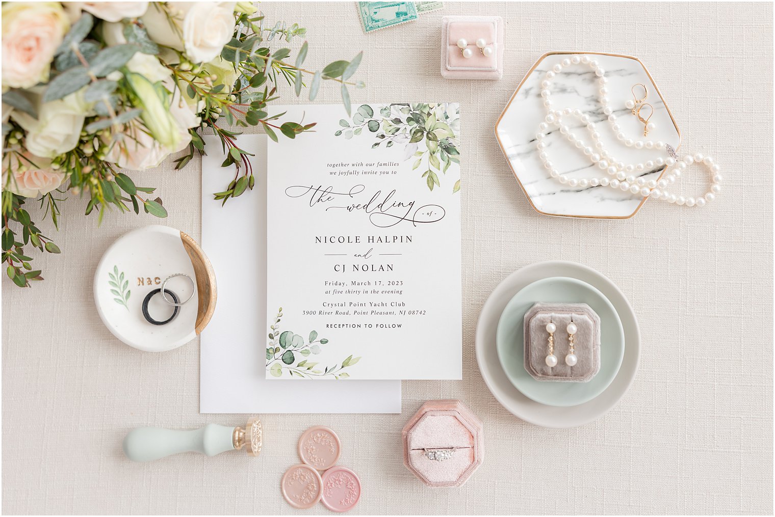 invitation suite with green leaves and jewelry with pink ring box