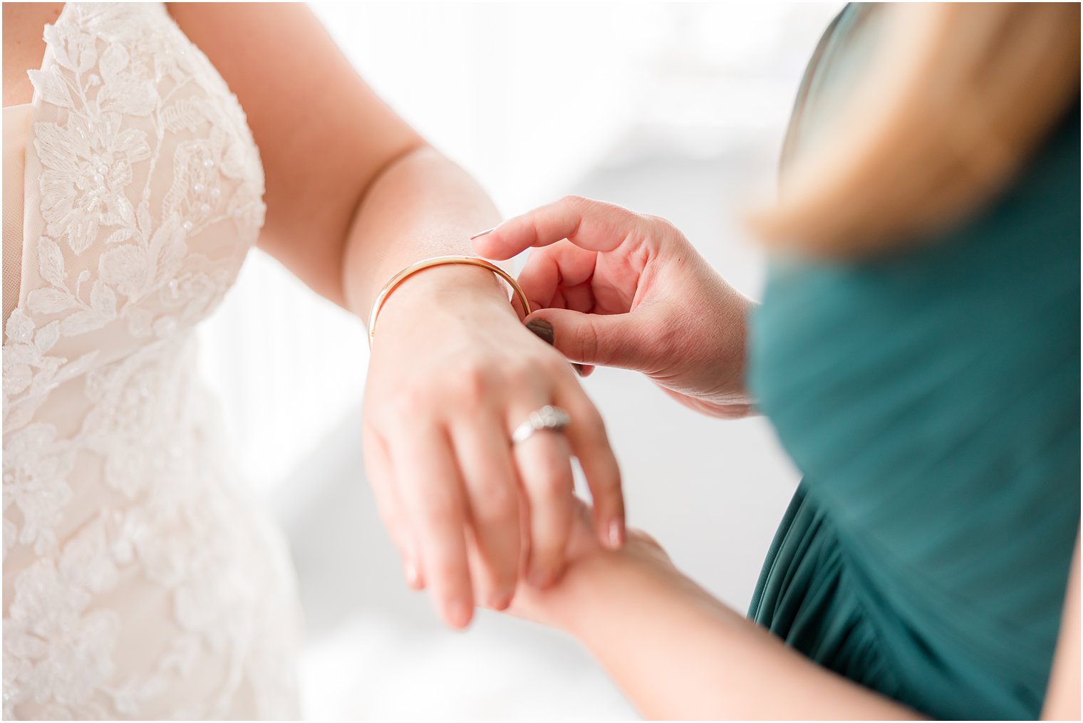 bridesmaid helps bride with bracelet at Crystal Point Yacht Club
