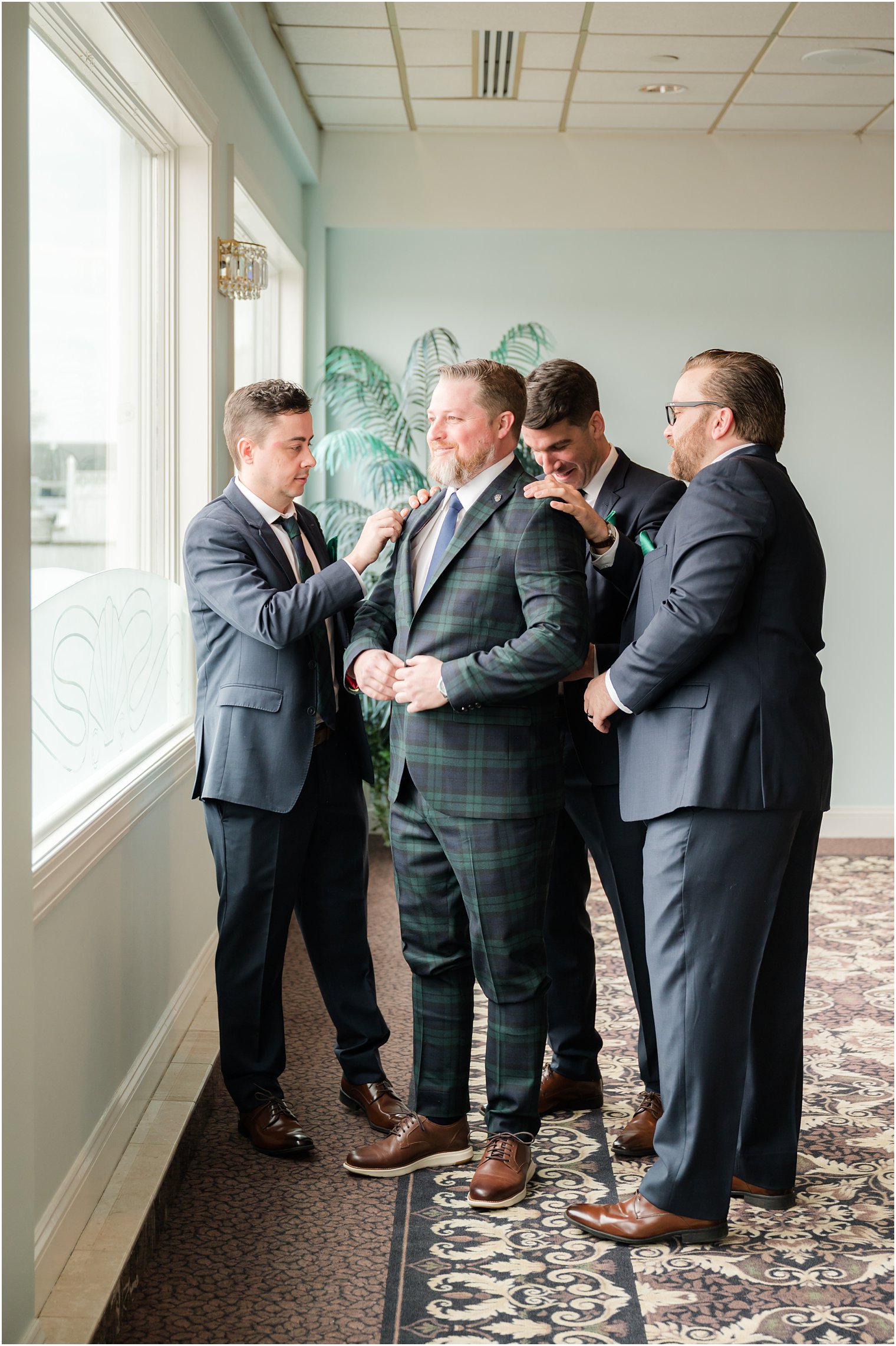 groomsmen help groom prepare for NJ wedding day
