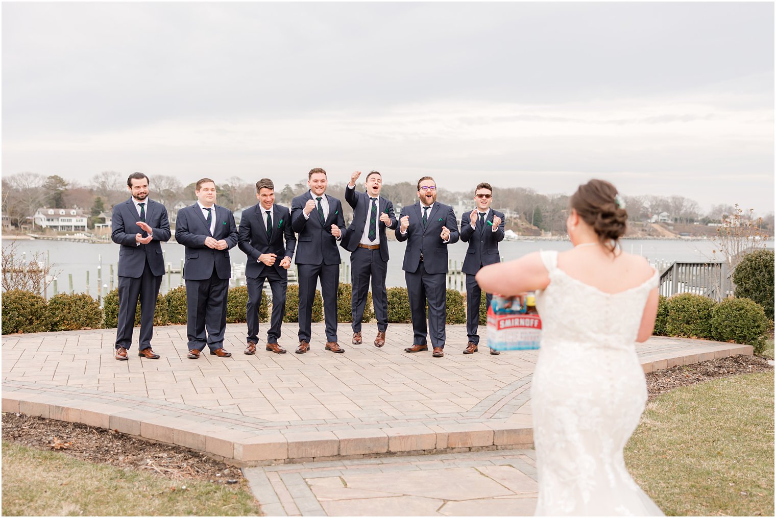 bride approaches groomsmen for first look at Crystal Point Yacht Club