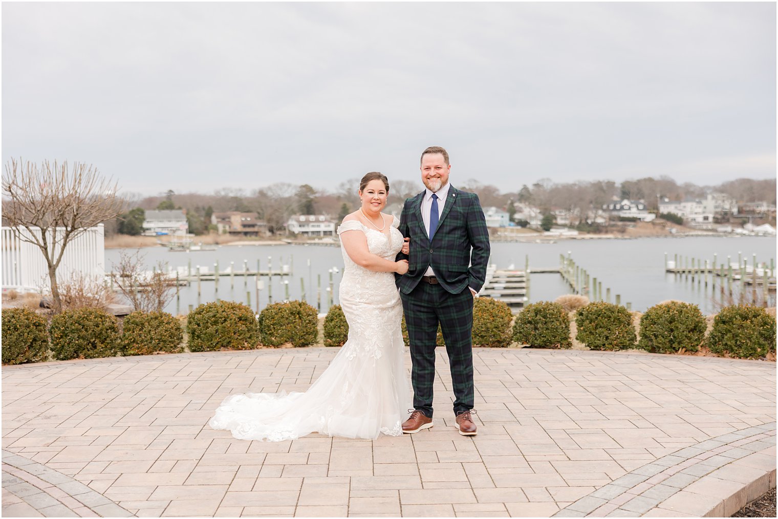 bride and groom stand on brick patio at Crystal Point Yacht Club