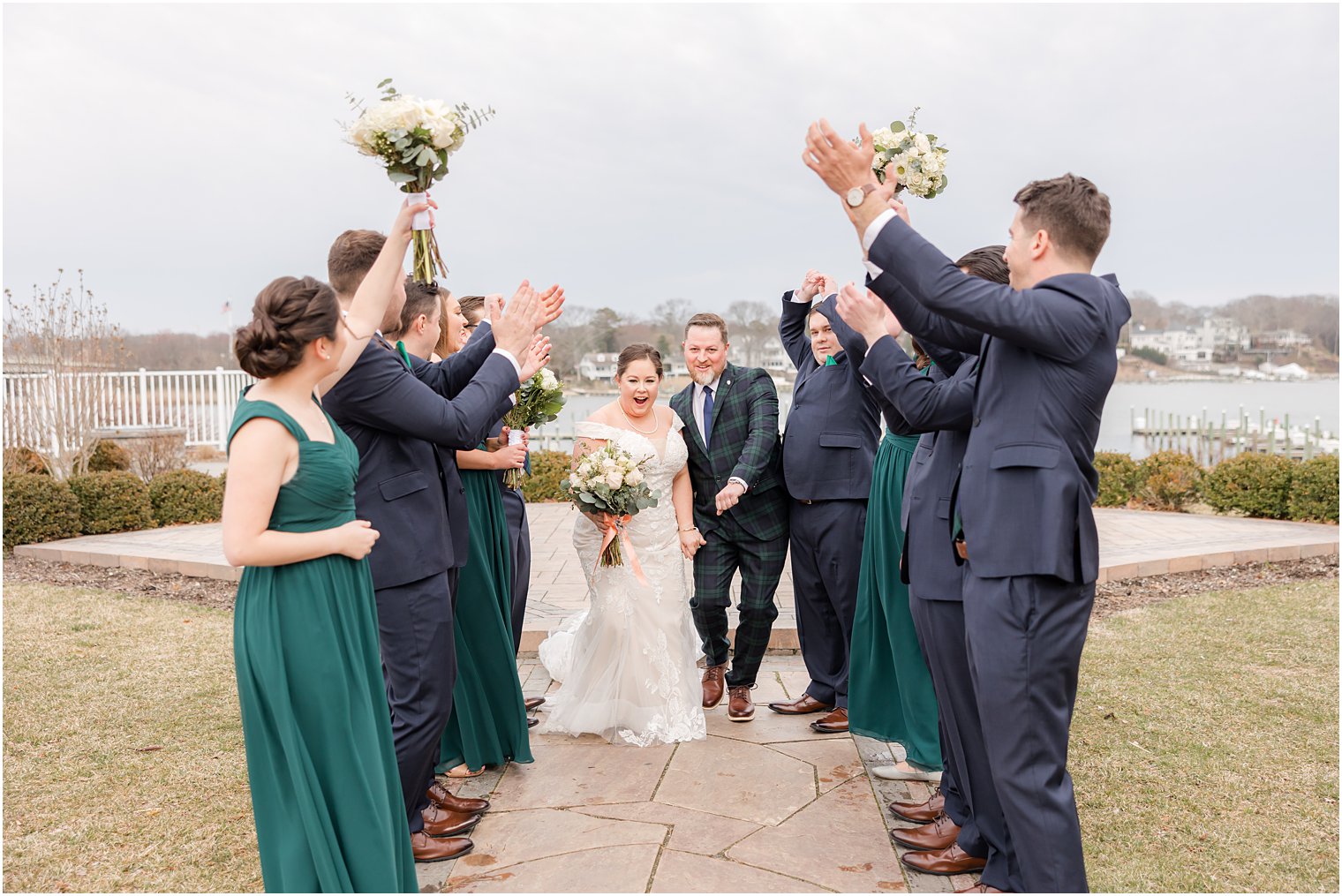 newlyweds walk through wedding party at Crystal Point Yacht Club