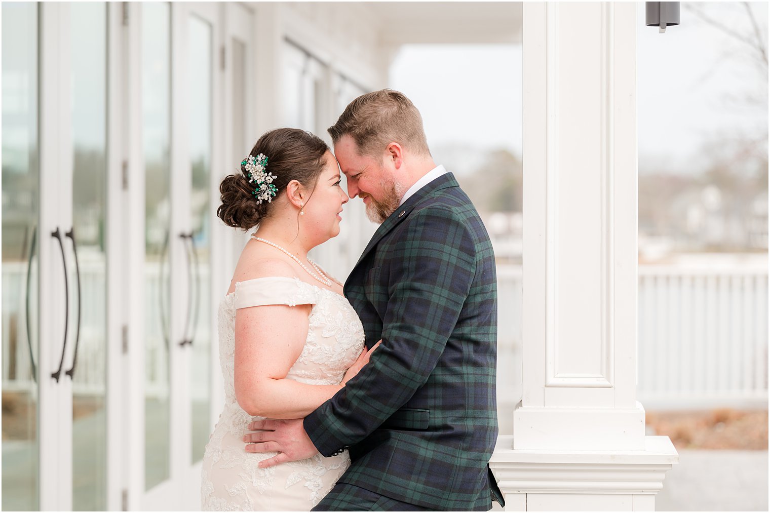 newlyweds hug leaning heads together at Crystal Point Yacht Club