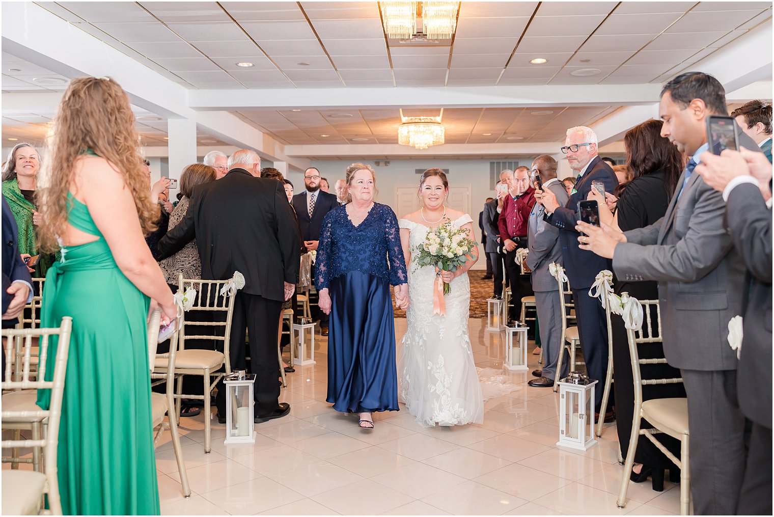 bride walks down aisle with mother 