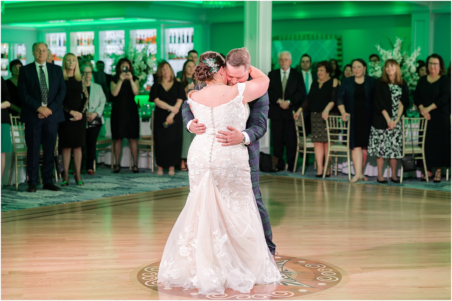 bride and groom hug on dance floor at Crystal Point Yacht Club