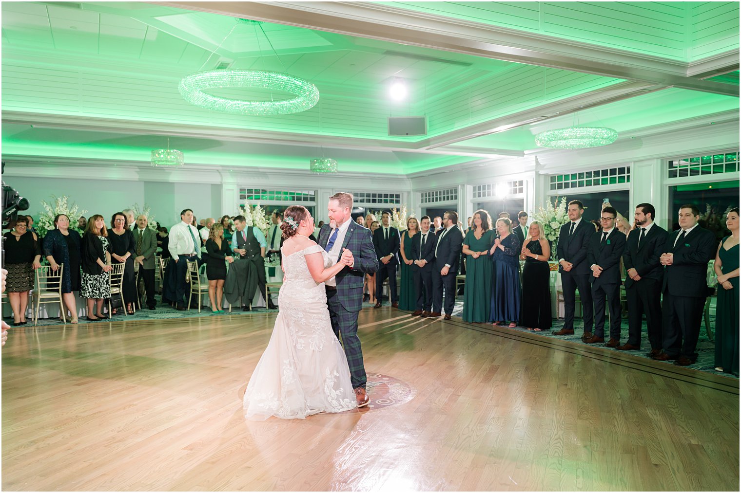 bride dances with groom on dance floor at Crystal Point Yacht Club