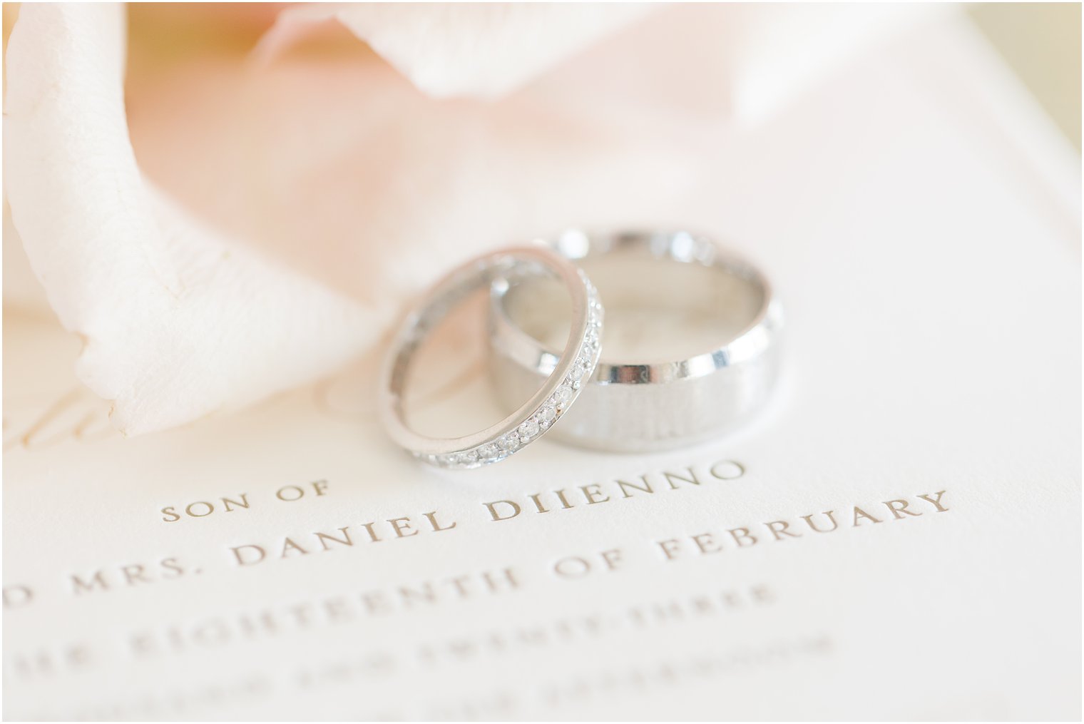 silver wedding bands lay on invitation for winter wedding at Park Chateau Estate