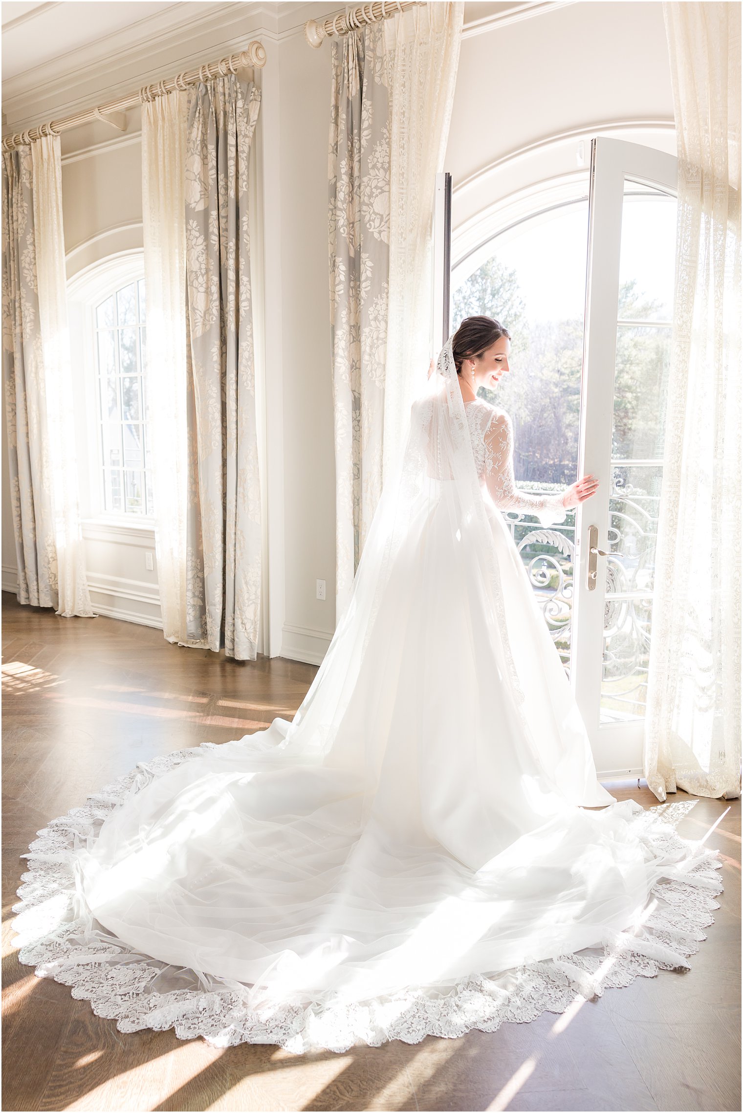 bride looks out window before winter wedding at Park Chateau Estate
