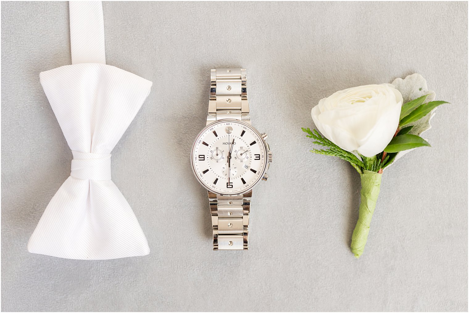 groom's white tie and silver watch 