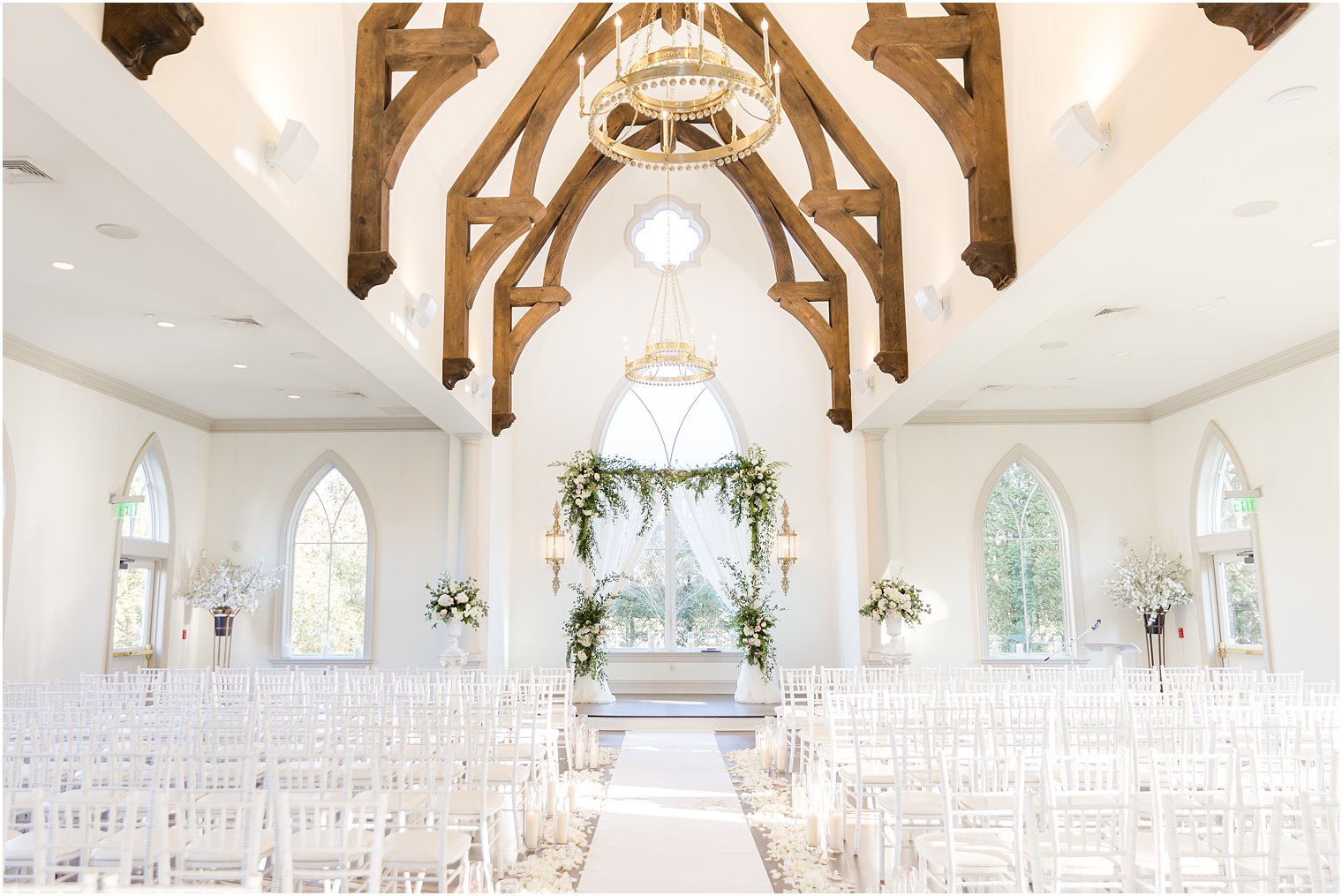 chapel at Park Chateau Estate with candles lining aisle and green arbor 