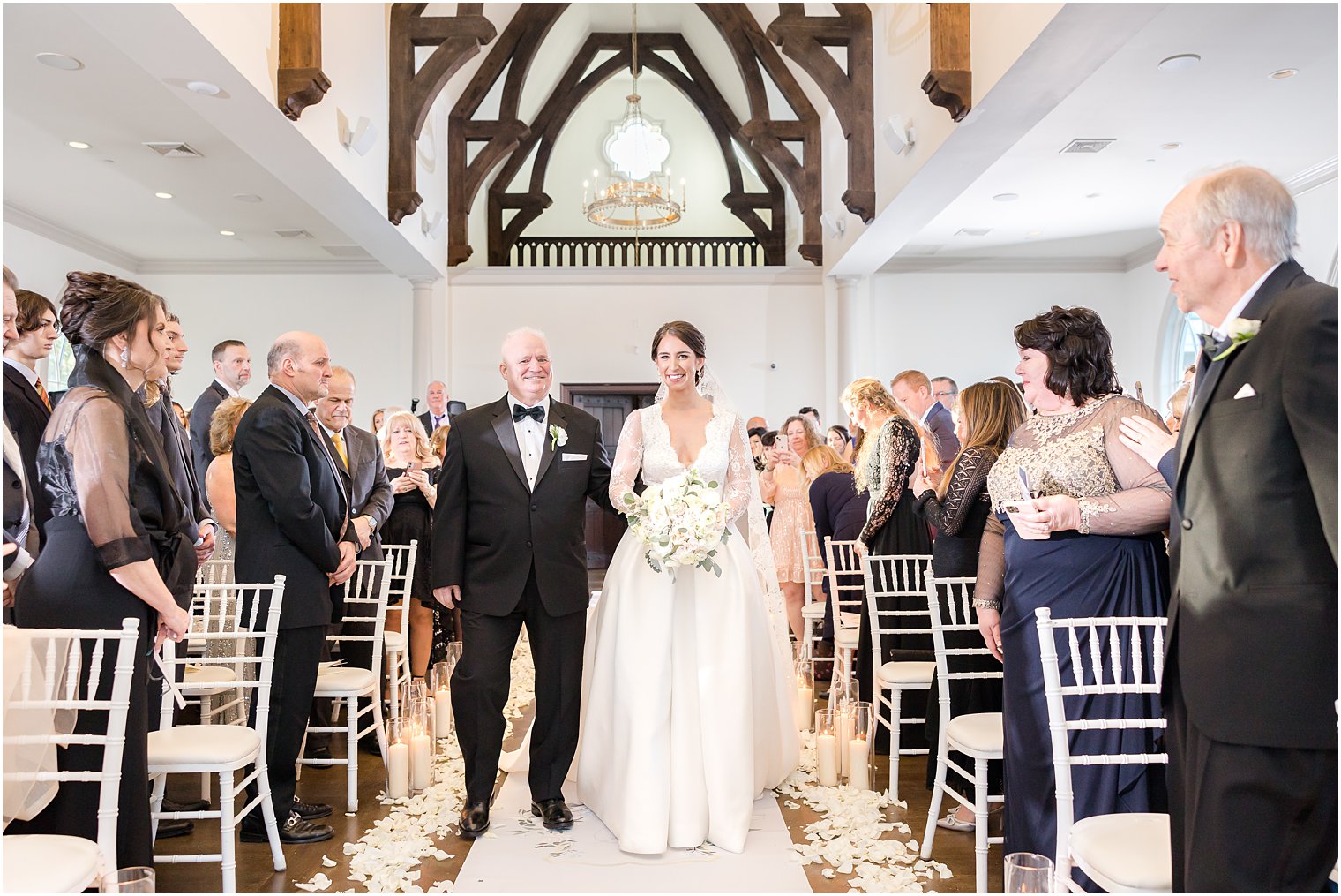 bride walks down aisle with father at Park Chateau Estate's chapel 