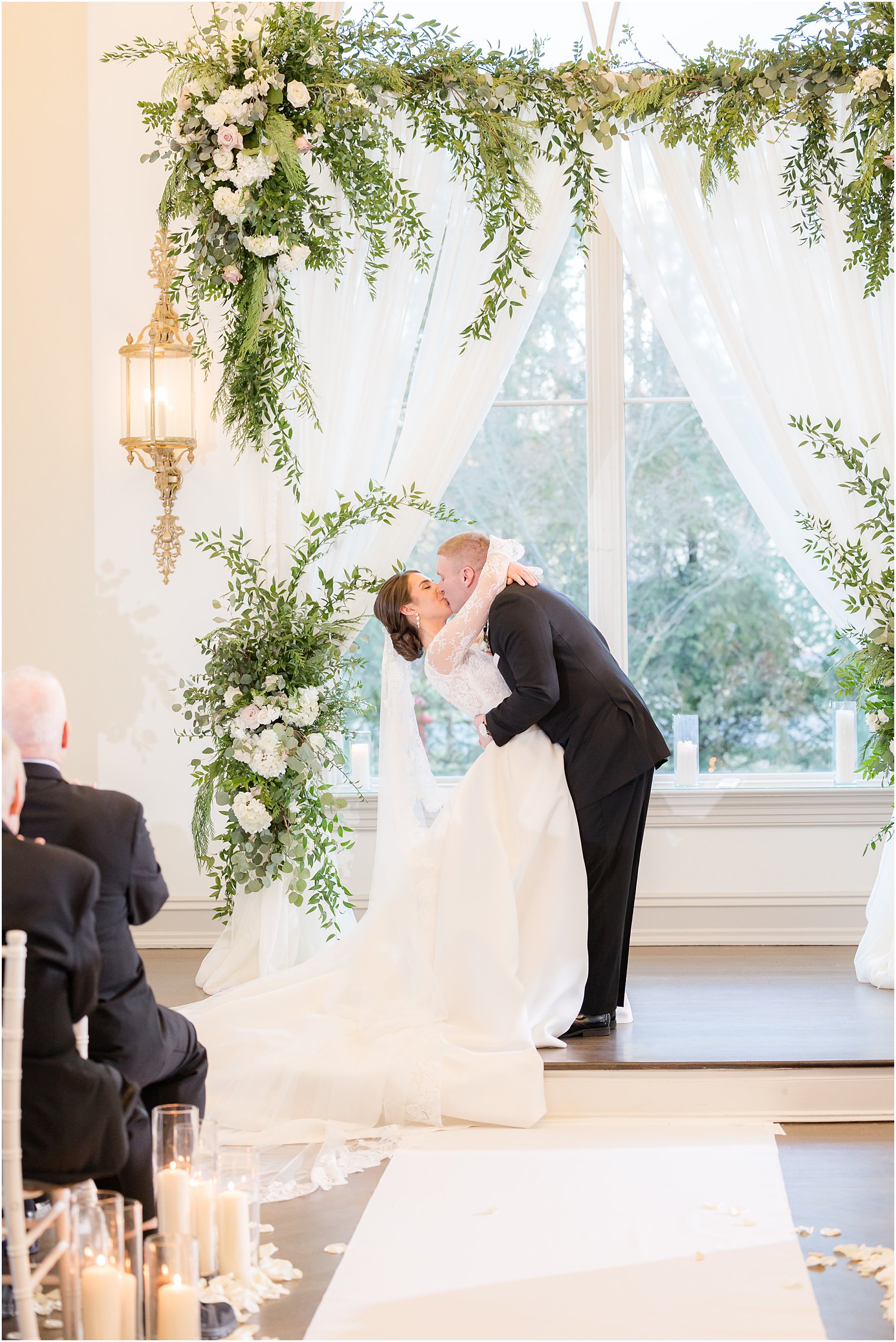 groom kisses bride during ceremony at Park Chateau Estate