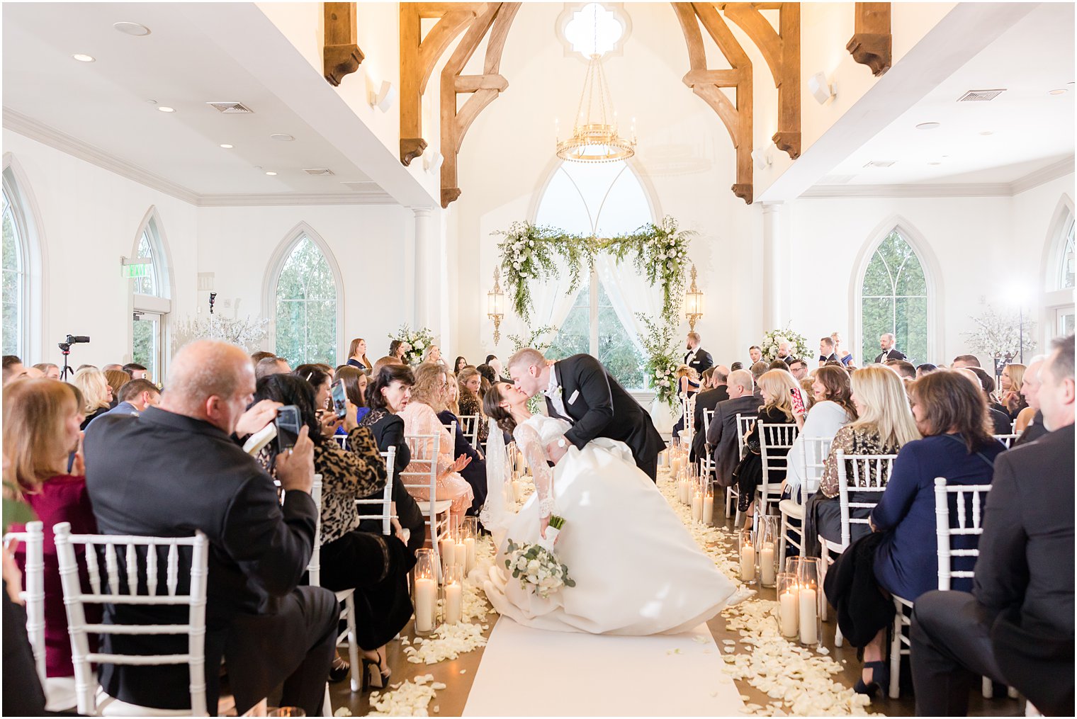 bride and groom kiss in aisle after ceremony in Park Chateau Estate