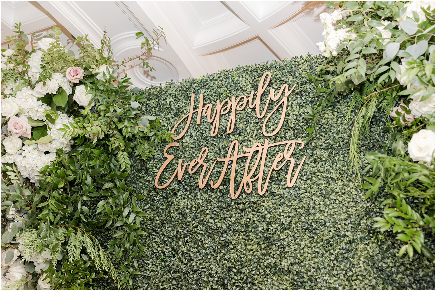 greenery wall with happily ever after sign at Park Chateau Estate