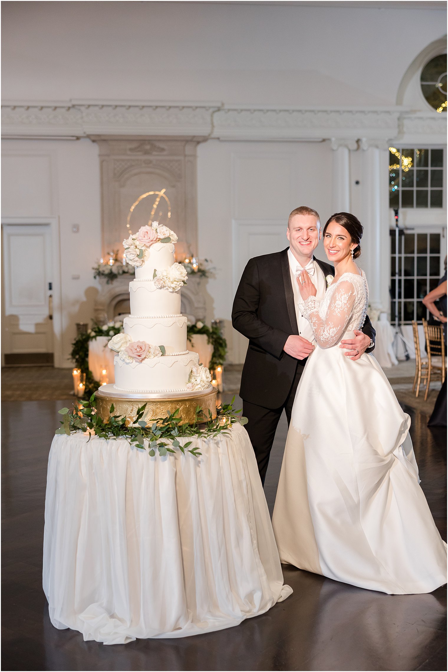 bride and groom hug by cake at Park Chateau Estate
