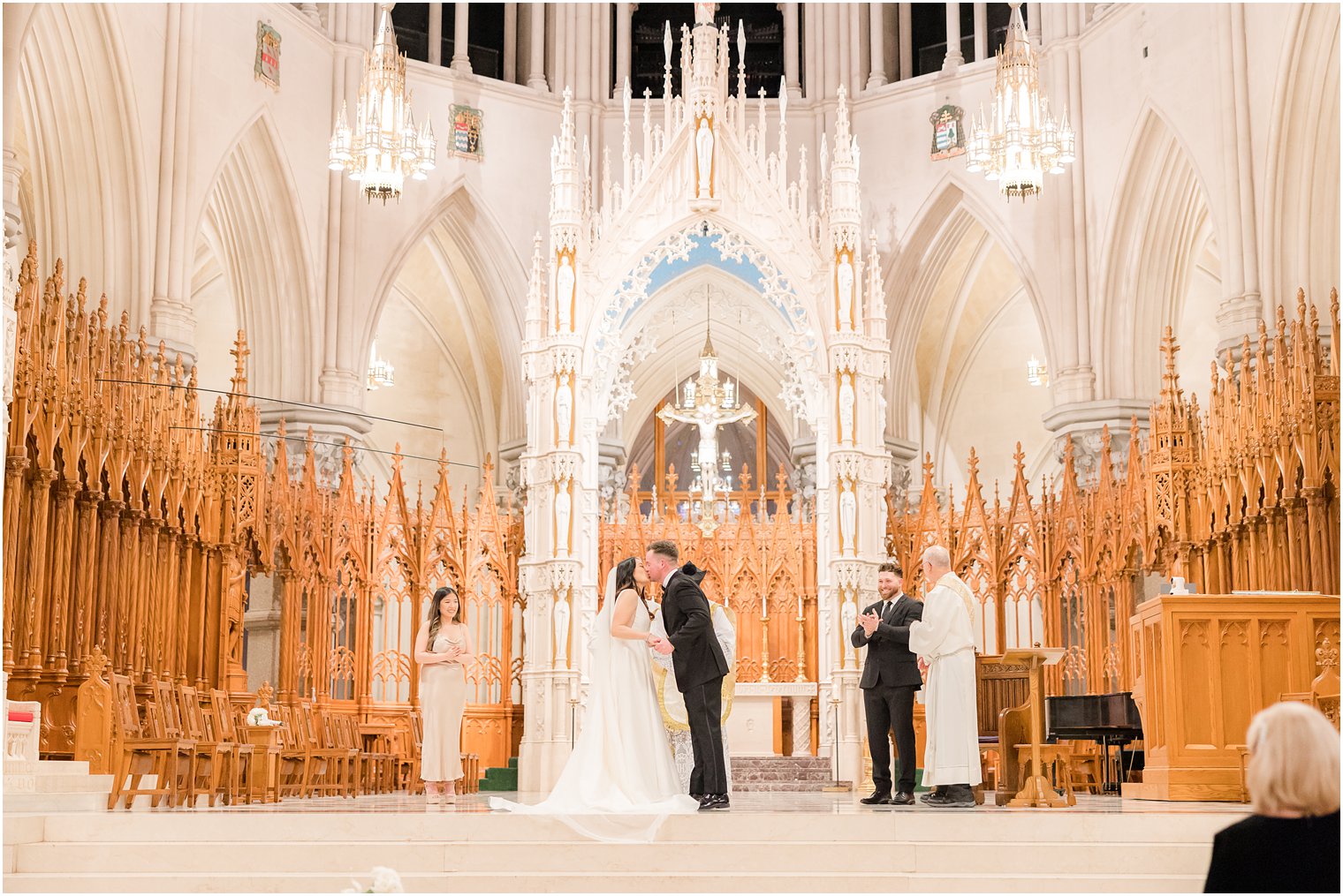 groom dips bride kissing her in The Cathedral Basilica of the Sacred Heart