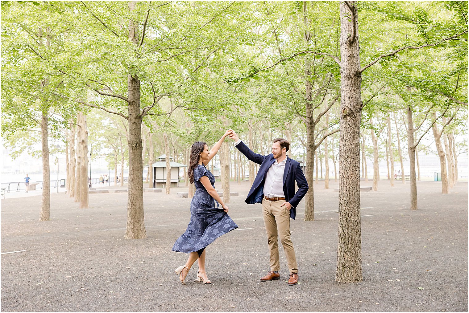 man twirls woman in Hoboken NJ park