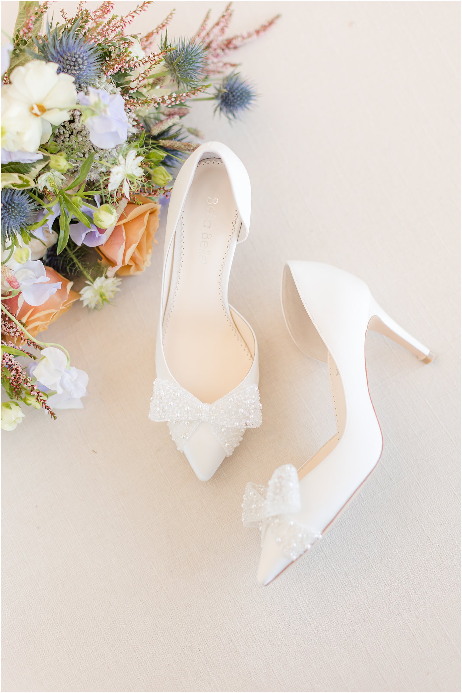 bride's white shoes with bow for spring wedding at Mallard Island Yacht Club