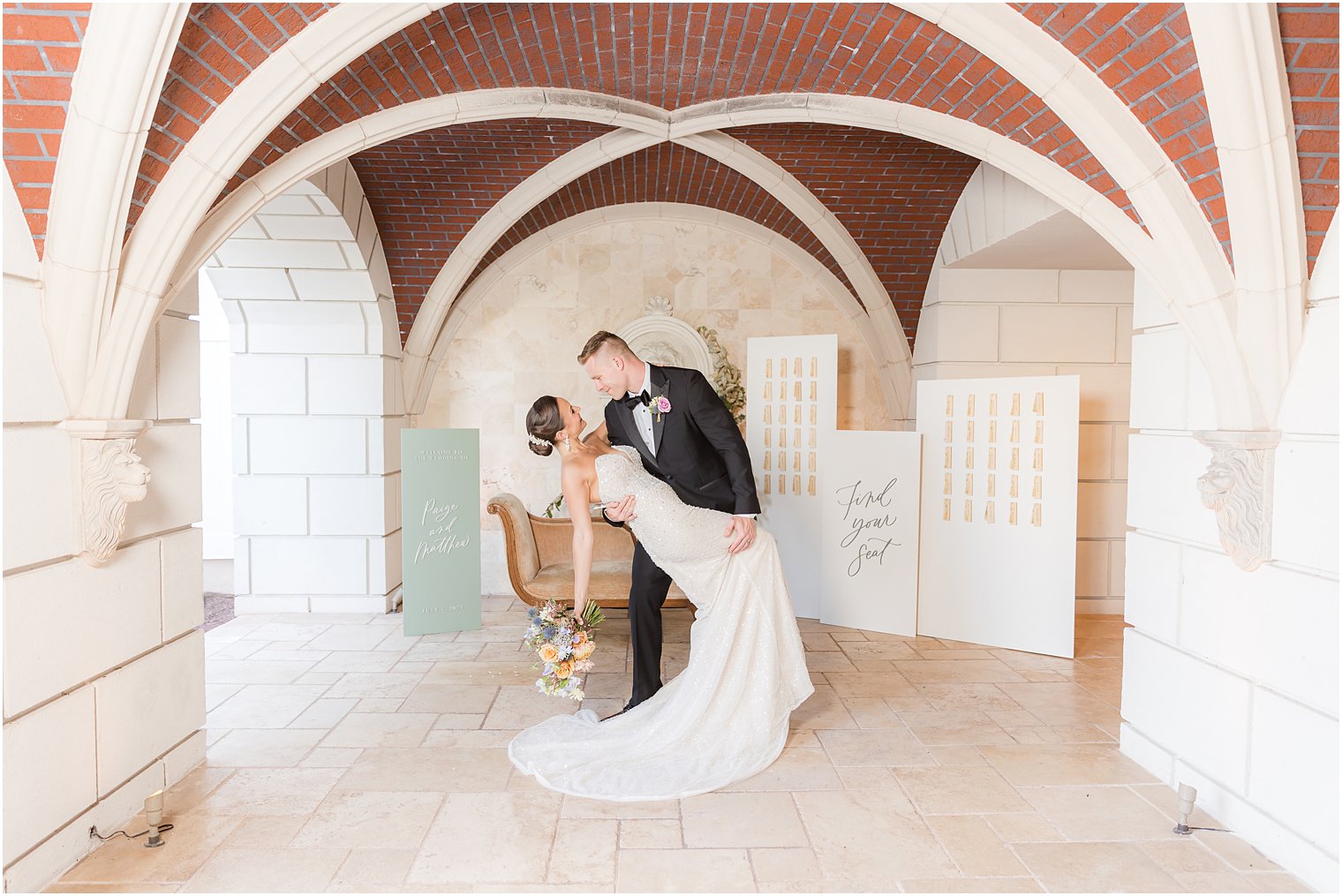 groom dips bride during portraits by seating chart for Mallard Island Yacht Club wedding