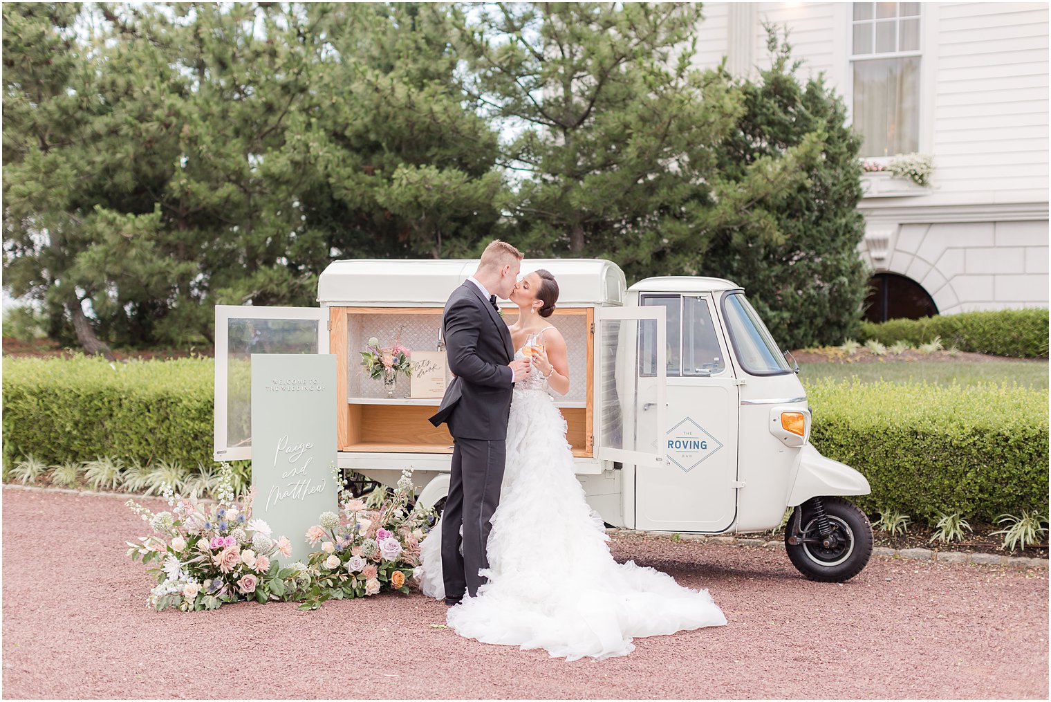 bride and groom kiss near mobile bar outside Mallard Island Yacht Club