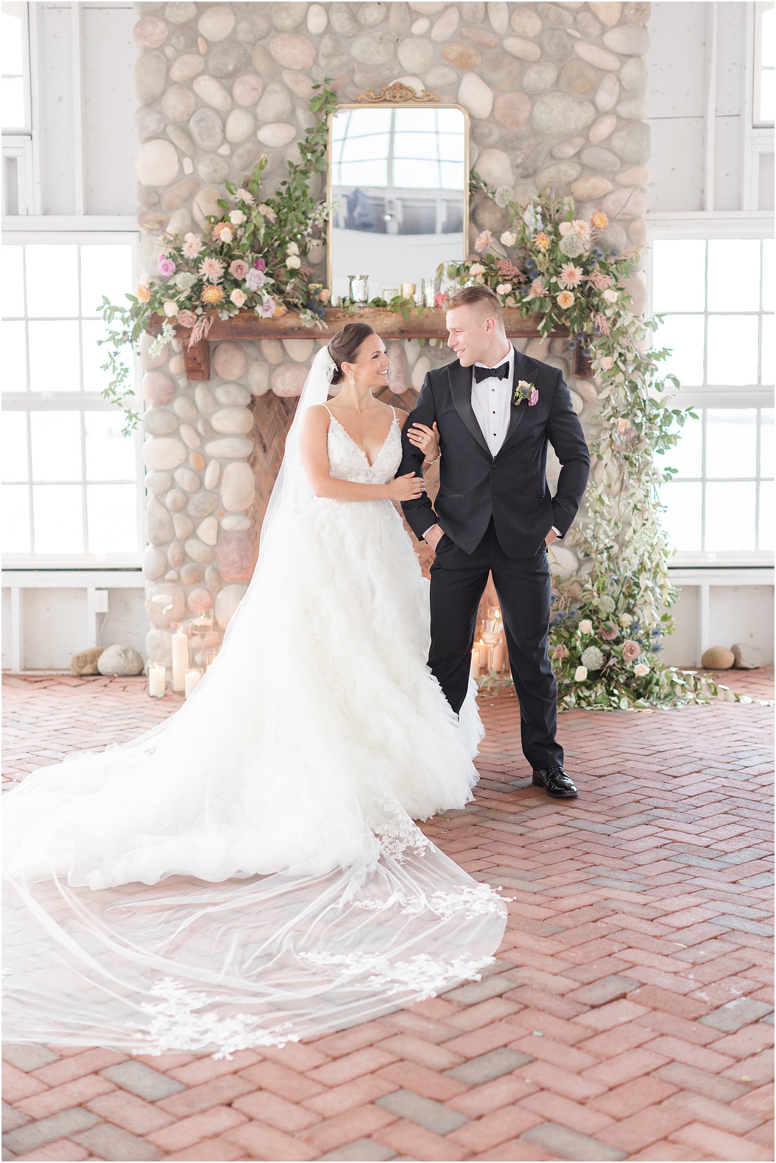 bride looks up at groom holding onto his arm in ceremony space at Mallard Island Yacht Club