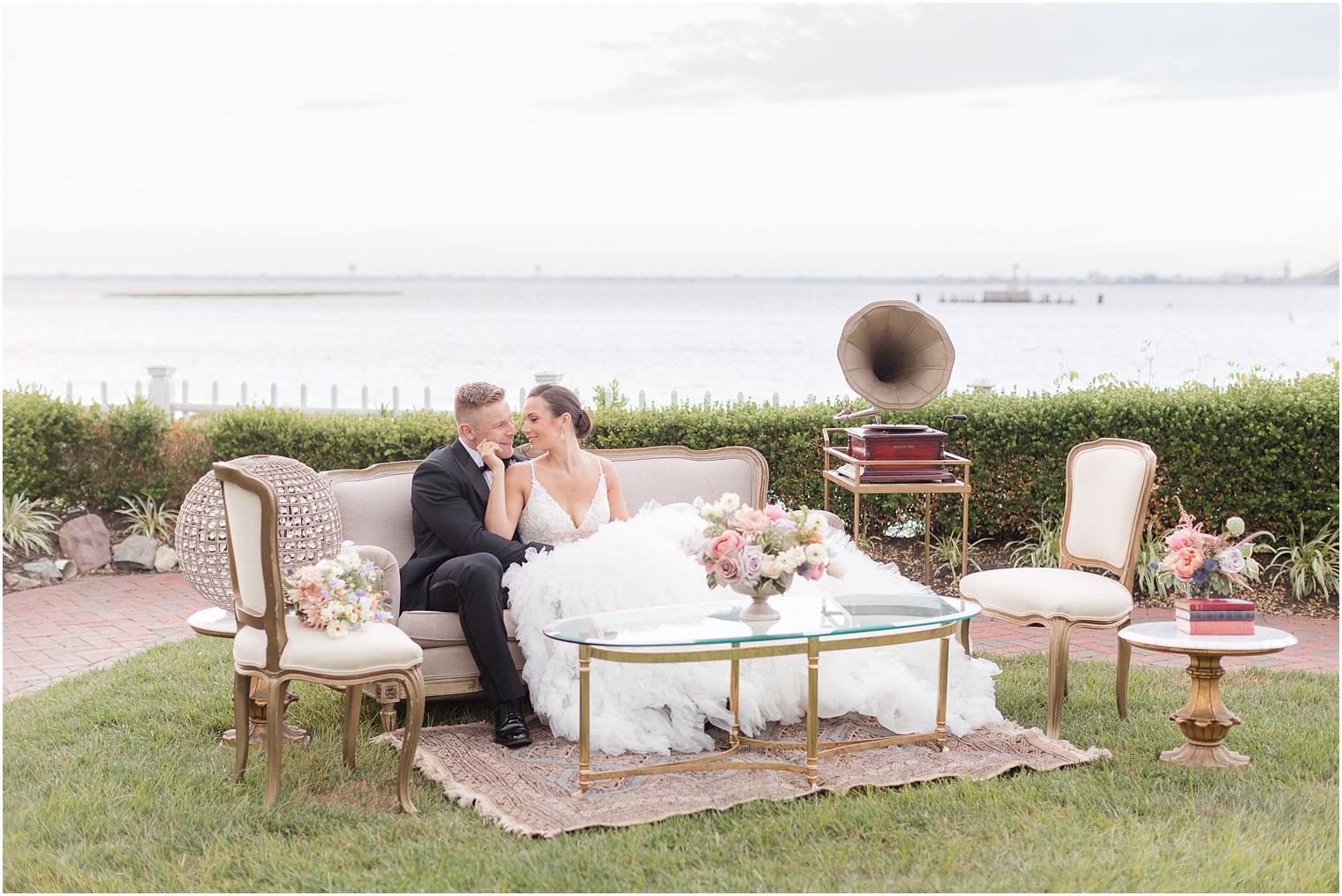 bride and groom snuggle on reception seating at Mallard Island Yacht Club