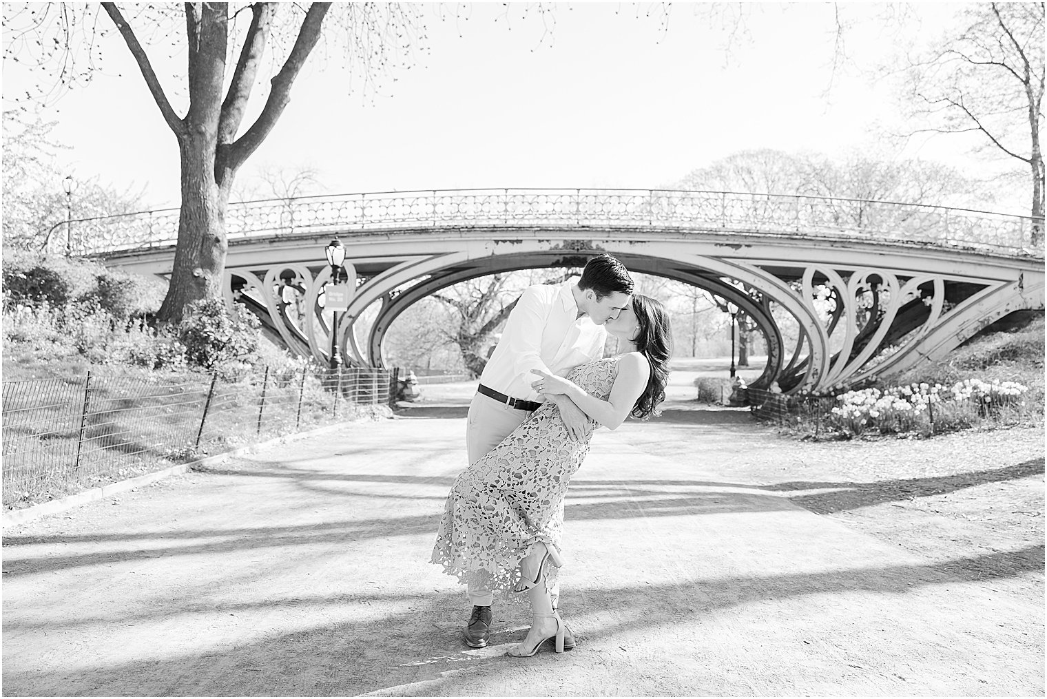 groom dips bride during New York City engagement session in Central Park