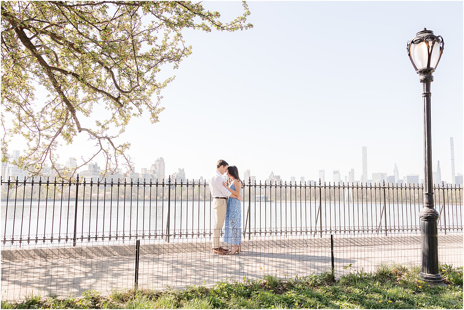 engaged couple hugs by waterfront in Central Pakr