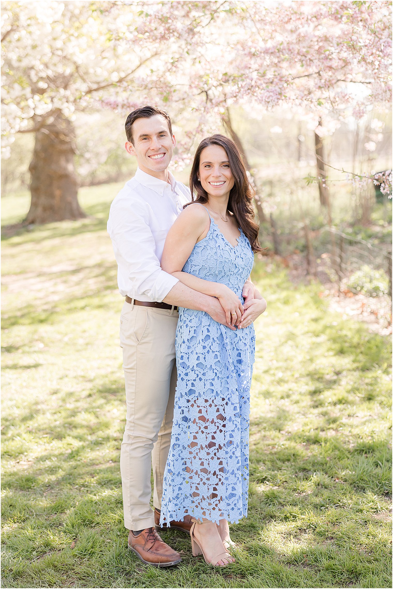 man stands behind woman during New York City engagement session in Central Park