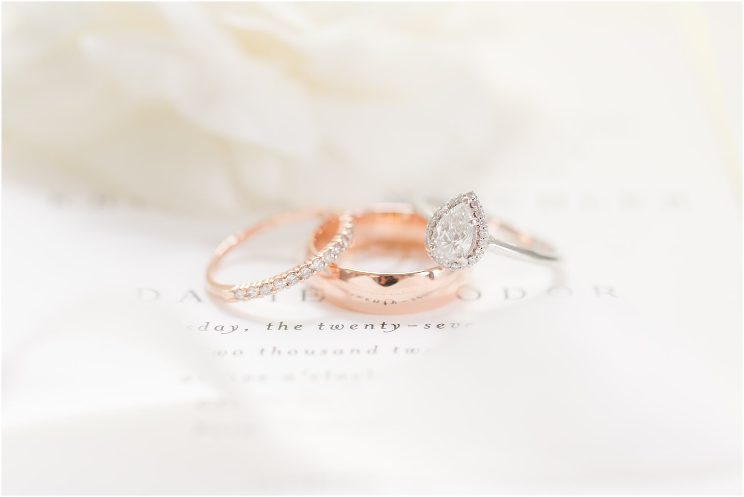 three wedding rings lay together on ivory sheet