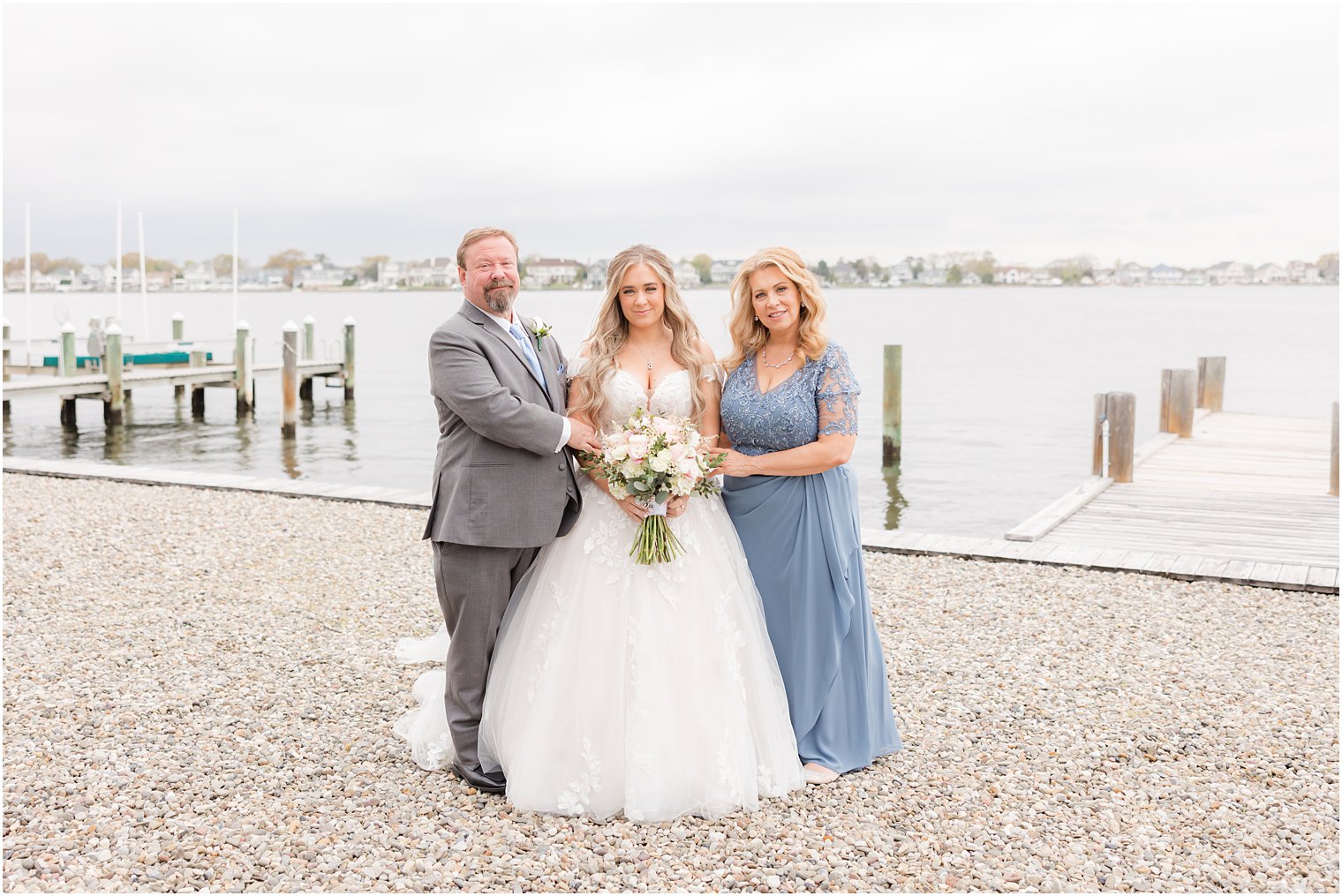 bride poses with mom and dad outside Point Pleasant NJ airbnb