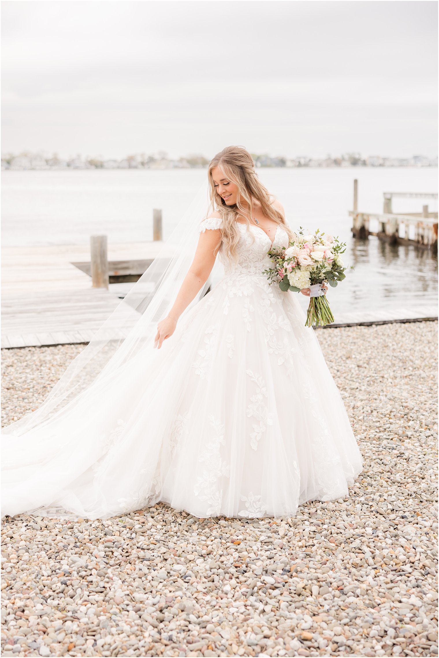 bride turns in wedding dress pulling veil behind her