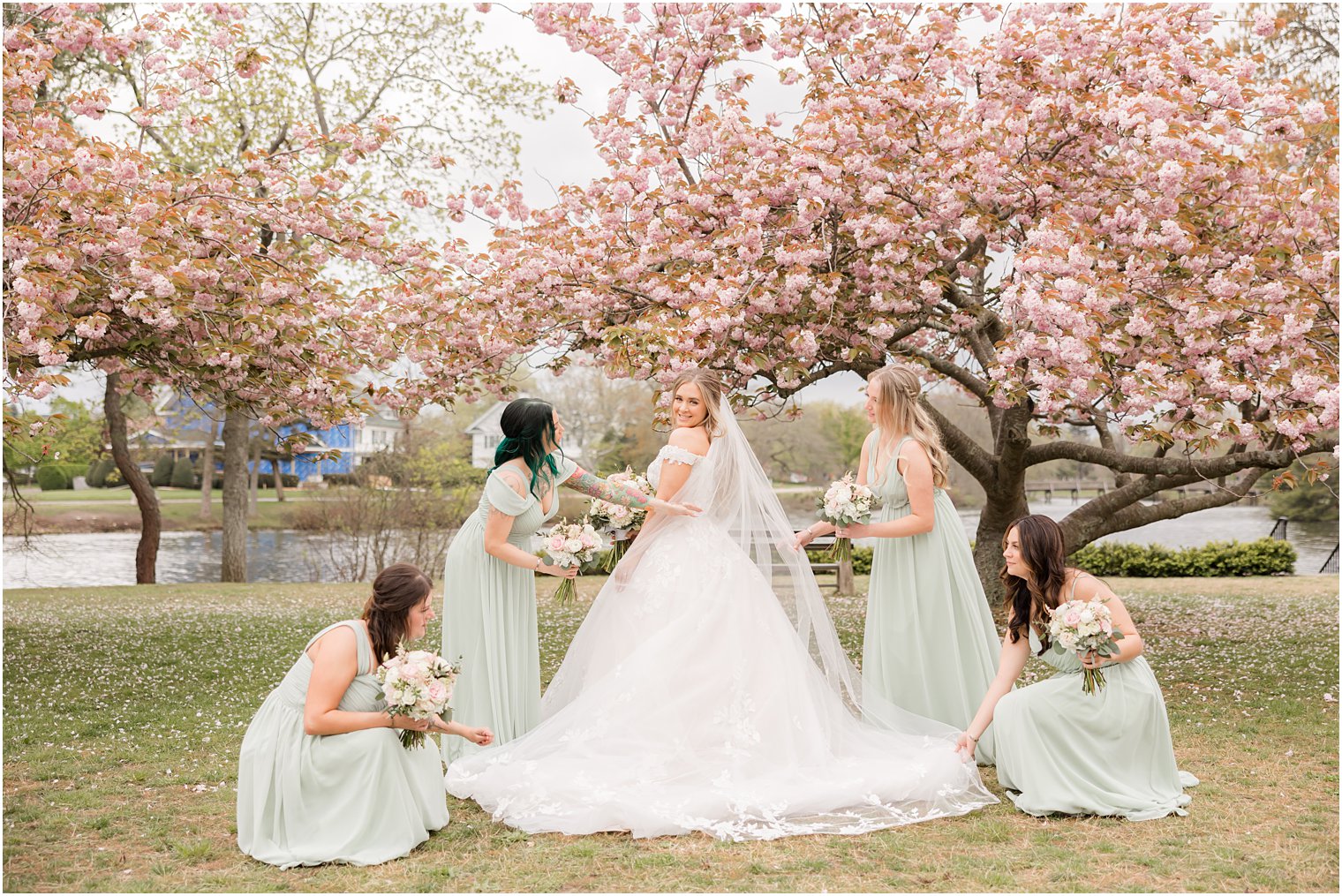 bridesmaids adjust bride's veil and skirt